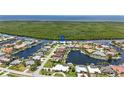 An aerial view of a waterfront neighborhood with canals, beautiful landscaping, and nearby ocean access at 3936 Crooked Island Dr, Punta Gorda, FL 33950
