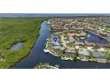 An aerial view of a waterfront neighborhood with lush foliage, serene water views, and easy boat access at 3936 Crooked Island Dr, Punta Gorda, FL 33950