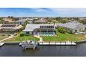 Waterfront property featuring screened-in pool, private dock, and picturesque views of the surrounding community at 3936 Crooked Island Dr, Punta Gorda, FL 33950