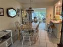 Traditional dining room with a wooden table, six chairs, and views into the sunroom at 405 Bryn Mawr Is, Bradenton, FL 34207