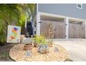 Stylish front yard with a gravel bed, potted plants, decorative ornaments, and a 'Welcome' sign at 4100 Miramar Way, St Petersburg, FL 33705