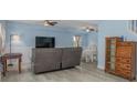 Bright living room featuring pale blue walls, laminate floors, a large TV, and comfortable seating at 4100 Miramar Way, St Petersburg, FL 33705