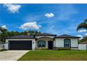 Charming single-Gathering home featuring a well-manicured lawn and a two-car garage at 4264 Michaler St, North Port, FL 34286