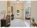 Inviting home foyer with an oval glass front door and neutral-colored flooring and accents at 4264 Michaler St, North Port, FL 34286