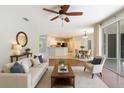 Bright open-concept living room features wood floors, ceiling fan, and sliders to the lanai at 4264 Michaler St, North Port, FL 34286