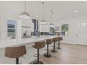 Bright and airy kitchen with a huge island, bar stool seating, and modern pendant lighting at 4513 21St N St, St Petersburg, FL 33714