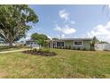 Well-kept single-story home with lush green lawn, featuring a delightful garden at 5685 35Th N Ave, St Petersburg, FL 33710