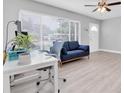 Bright living room featuring neutral walls, a comfortable sofa, and a well-lit workspace at 5685 35Th N Ave, St Petersburg, FL 33710