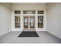 Elegant double front doors with decorative ironwork and transom windows, creating a grand entrance at 6411 Barton Rd, Plant City, FL 33565