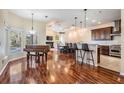 Open-concept living space with hardwood floors, fireplace, and a seamless flow to the kitchen at 6411 Barton Rd, Plant City, FL 33565
