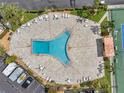 Aerial view of community pool area featuring ample seating, shade, and tennis courts at 7600 Sun Island S Dr # 407, South Pasadena, FL 33707