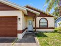 Welcoming front entrance with decorative glass door, arched window, and easy access to the attached garage at 7712 40Th N Ter, St Petersburg, FL 33709