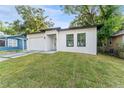 Charming single-story home boasts a freshly painted exterior, a new roof, and a well-maintained yard at 8112 N 10Th St, Tampa, FL 33604
