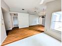 Open-concept living space with windows, laminate flooring and grey walls at 8209 Volusia Pl, Tampa, FL 33637