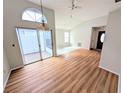 Spacious living area with sliding glass doors and laminate flooring at 8209 Volusia Pl, Tampa, FL 33637
