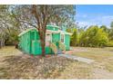 Quaint green home with new wooden porch railing offering curb appeal and charm at 8215 N 14Th St, Tampa, FL 33604