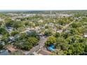 Scenic aerial view of a neighborhood, showcasing lush greenery, well-maintained homes, and vibrant streets at 8525 N Ola Ave, Tampa, FL 33604