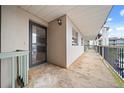 View of the covered patio with door leading inside the condo at 1028 Apollo Beach Blvd # 203, Apollo Beach, FL 33572