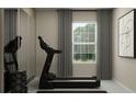 Bright exercise room with treadmill, weight rack, mirror and a large window at 11084 E 65Th Ter, Palmetto, FL 34221