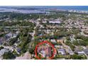Aerial view of the property and neighborhood, showcasing the surrounding community with views of the bay at 13725 Oak Forest N Blvd, Seminole, FL 33776