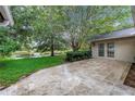 Paver patio overlooks lush green lawn and tranquil lake views at 13898 Egret Ln, Clearwater, FL 33762