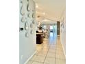 Inviting hallway with neutral tile floors leading to an open living area at 14015 Arbor Pines Dr, Riverview, FL 33579