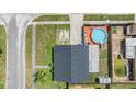 Aerial view showcasing backyard swimming pool, fenced yard, and surrounding neighborhood at 16023 Splitlog Dr, Tampa, FL 33618