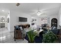 Inviting living room with ample natural light, neutral walls, tile floor, and modern furnishings at 16023 Splitlog Dr, Tampa, FL 33618