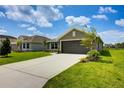 Well maintained single Gathering home with large driveway, nice lawn and tropical landscaping at 16503 66Th E Ln, Parrish, FL 34219