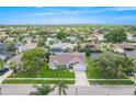 Community aerial view showcasing a home with a pool, surrounded by lush trees at 1838 Eagle Ridge Blvd, Palm Harbor, FL 34685