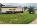 Fairway Villas community sign with manicured landscaping and lush green grass at 18804 Tournament Trl, Tampa, FL 33647