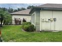 Side view of a home with lush landscaping and a well-maintained exterior at 18804 Tournament Trl, Tampa, FL 33647