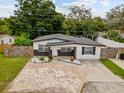 Lovely home showcasing manicured landscaping, decorative rock, and spacious driveway at 2112 Ranchita Trl, Holiday, FL 34690