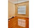 Elegant dining room featuring hardwood floors, a chandelier, and a large window at 23112 Emerson Way, Land O Lakes, FL 34639