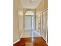 Inviting foyer with tile flooring, a decorative front door, and neutral paint at 23112 Emerson Way, Land O Lakes, FL 34639