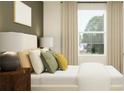 Cozy bedroom featuring a large window with blinds, providing natural light and street view at 234 Se 27Th St, Ruskin, FL 33570
