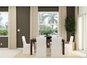Bright dining room with a dark wood table and white chairs, perfect for Gathering meals at 234 Se 27Th St, Ruskin, FL 33570