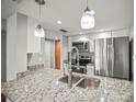 Kitchen with stainless steel appliances, granite countertops, and a double sink with modern faucet at 2581 Countryside Blvd # 2309, Clearwater, FL 33761