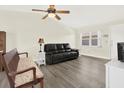 Living room features laminate floors, ceiling fan and ample seating at 3146 37Th S Ln # A, St Petersburg, FL 33711
