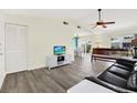 Open-concept living room showcasing updated flooring, neutral walls, and a ceiling fan for comfortable living at 3146 37Th S Ln # A, St Petersburg, FL 33711