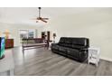 Bright living room featuring new flooring, a ceiling fan, neutral paint, and access to a patio at 3146 37Th S Ln # A, St Petersburg, FL 33711