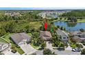 An aerial view of a residential home within a picturesque neighborhood near a lake at 32193 Watoga Loop, Wesley Chapel, FL 33543