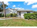 Inviting front entrance to a charming one-story condo with a well-maintained lawn and some shrubbery at 3268 39Th S St # A, St Petersburg, FL 33711