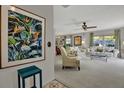 Comfortable living room featuring large windows, soft carpet, and floral patterned sofas at 3268 39Th S St # A, St Petersburg, FL 33711