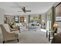 Bright living room featuring plenty of sunlight, plush carpeting, and open access to the dining area at 3268 39Th S St # A, St Petersburg, FL 33711