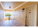 Hallway to unit 303 with tiled floors and a view to the outside waterway with mangroves at 4345 Bayside Village Dr # 303, Tampa, FL 33615