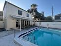Community swimming pool and white fenced-in patio, great for entertaining at 4611 W North B St # 125, Tampa, FL 33609