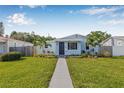 Charming single-story home with a well-manicured lawn and inviting walkway at 4755 21St N Ave, St Petersburg, FL 33713