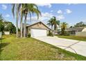 Inviting home with a 2-car garage, well-maintained lawn and landscaping, and a charming covered entryway at 5112 Parkway Blvd, Land O Lakes, FL 34639
