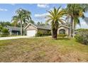 Well-maintained home with a 2-car garage, mature landscaping, and a tidy lawn enhancing its curb appeal at 5112 Parkway Blvd, Land O Lakes, FL 34639